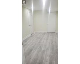 A room with wood flooring and white walls.