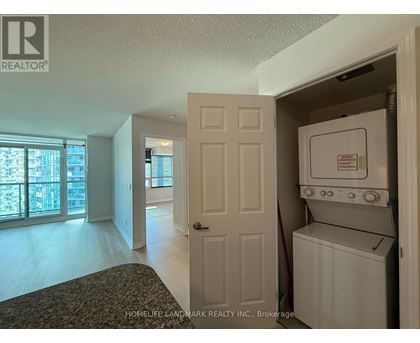 A white washer and dryer are in a small closet.