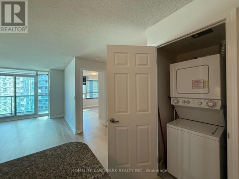 A white washer and dryer are in a small closet.