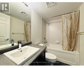 A white bathroom with a sink, toilet, and bathtub.