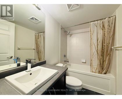 A white bathroom with a sink, toilet, and bathtub.