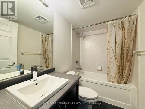 A white bathroom with a sink, toilet, and bathtub.