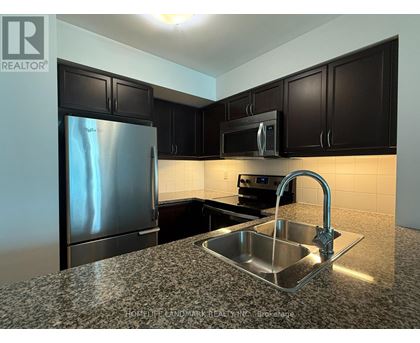 A kitchen with a sink and a refrigerator.