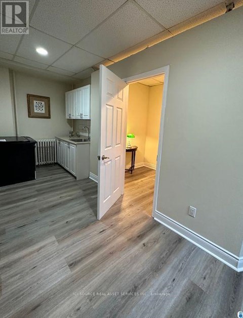 A room with a wooden floor and a white door.
