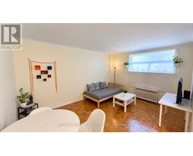 A living room with a couch, chair, and table.