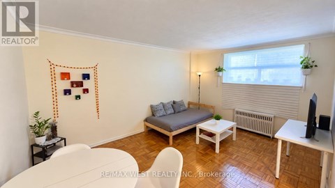 A living room with a couch, chair, and table.