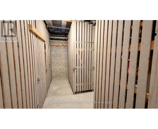 A long, narrow, unfinished room with wooden studs on the walls.