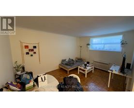A bedroom with a bed, desk, and chair.