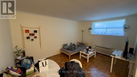A bedroom with a bed, desk, and chair.