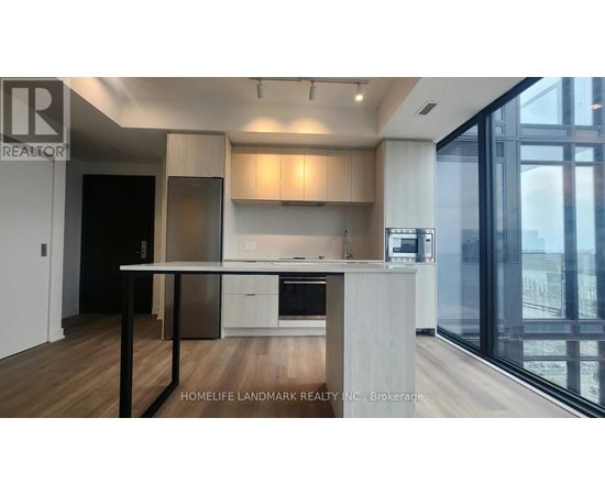 A modern kitchen with a dining table and chairs.