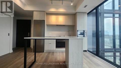 A modern kitchen with a dining table and chairs.