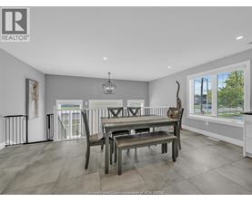 A dining room with a table set for four.