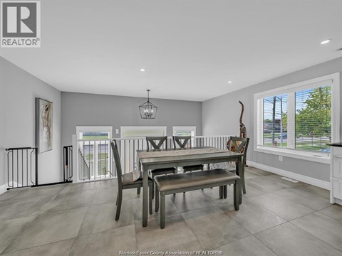 A dining room with a table set for four.