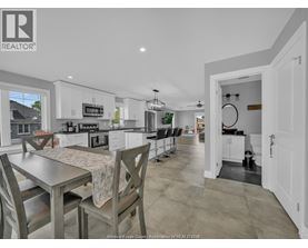 A kitchen with a table and chairs in front of it.