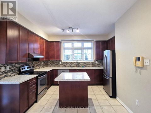 A kitchen with dark wood cabinets and granite countertops.