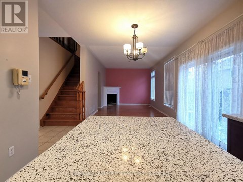 A large bedroom with a marble bed and a staircase in the background.