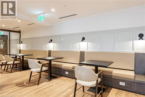 A modern dining area with wooden floors and white chairs.