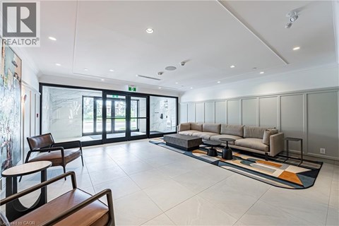 A spacious living room with a sofa set and a rug.