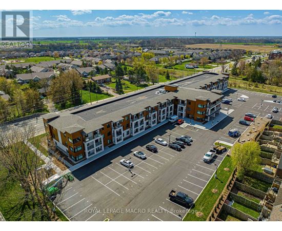 A parking lot in front of a building with the text "Royal LePage Macro Realty Brokerage" on it.