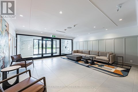 A spacious living room with a sofa set and a rug.