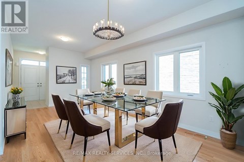 A dining room with a glass table and chairs.