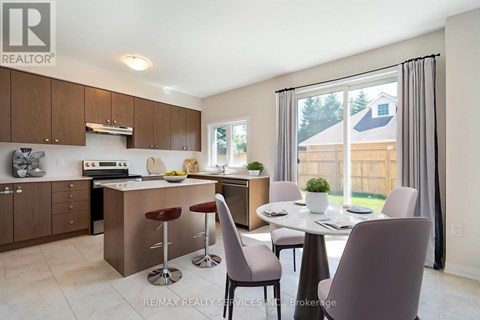 A modern kitchen with a dining table and chairs.