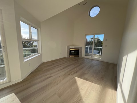 A room with wooden floors and a skylight.