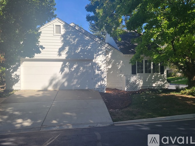 A house with a white garage door is for sale.