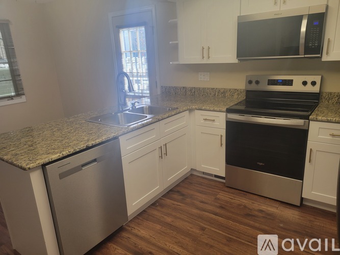 A kitchen with granite countertops and stainless steel appliances.