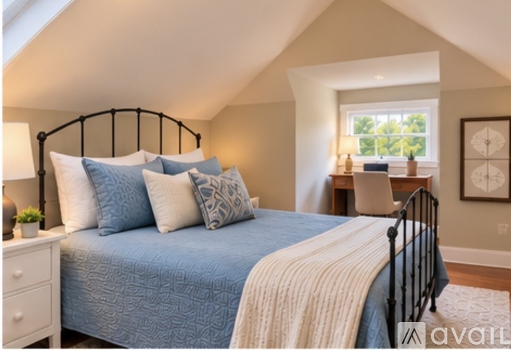 A bedroom with a bed, nightstand, and window.