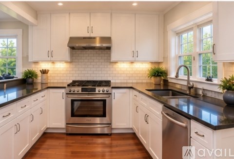 A kitchen with white cabinets and a stainless steel dishwasher.