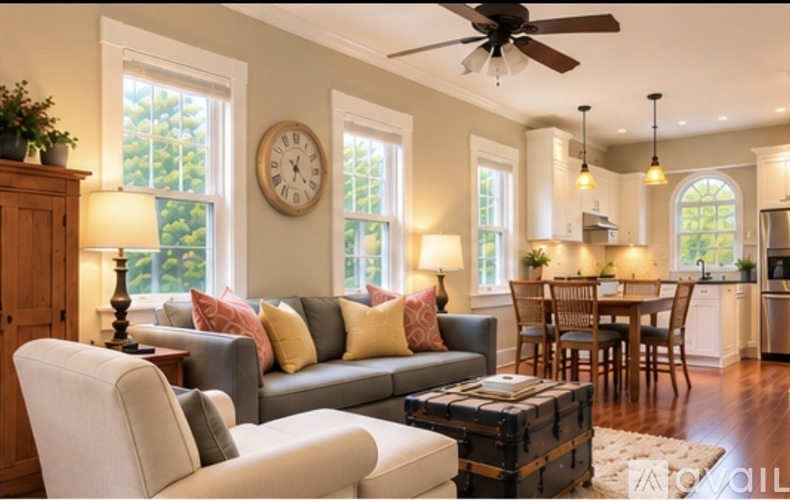 A living room with a grey couch and a wooden cabinet.