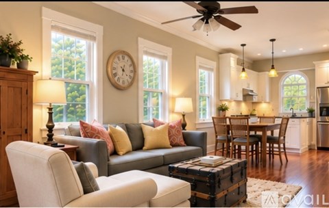 A living room with a grey couch and a wooden cabinet.