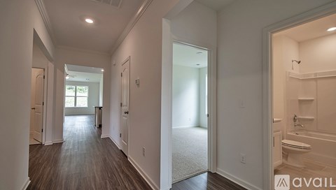 A spacious hallway with a toilet visible in the distance.