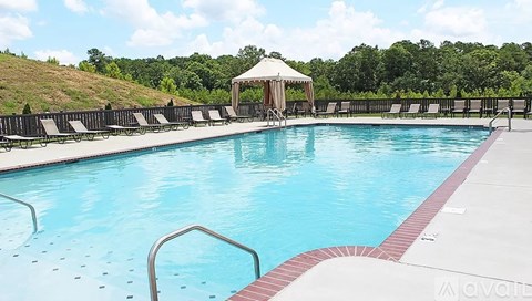 A large swimming pool with a gazebo in the background.