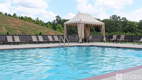 A pool with a gazebo in the middle of it.