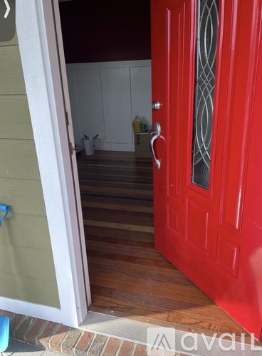 A red door with a glass panel and a metal handle.
