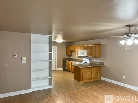 A kitchen with wooden cabinets and a countertop is available for rent.