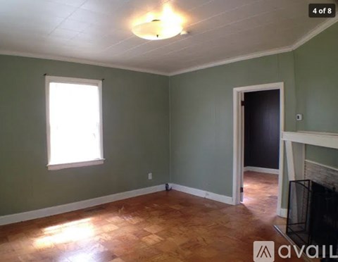 A room with a fireplace and a window.