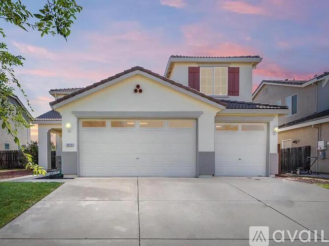 A two-story house with a garage is available for sale.