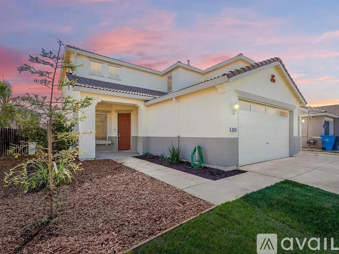 A two-story house with a garage and a driveway.