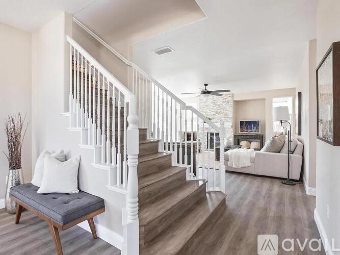 A living room with a staircase and a couch.
