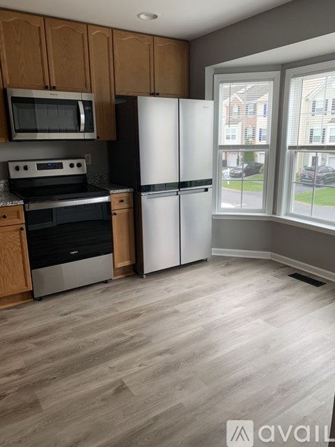 A kitchen with wooden cabinets and a white refrigerator.
