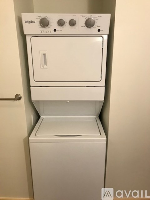 A Whirlpool dryer is white and has a control panel on top.