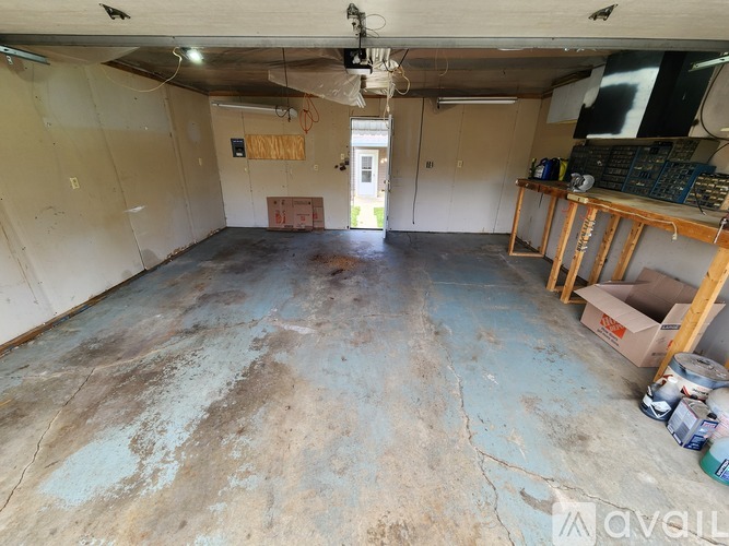 A room with a concrete floor and a ceiling fan.
