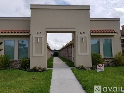 A house numbered 1432 is in front of a house numbered 1428.