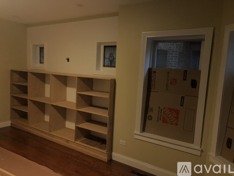 A room with a window and a shelving unit.