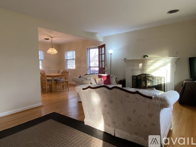 A bedroom with a large bed and a dining table with chairs.