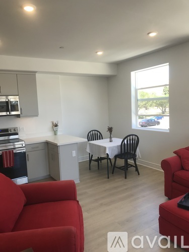 A living room with a dining table and chairs.