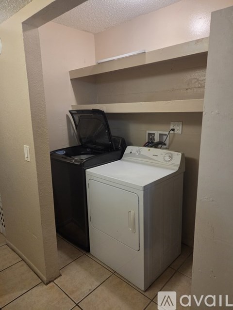 A washer and dryer are in a small room.